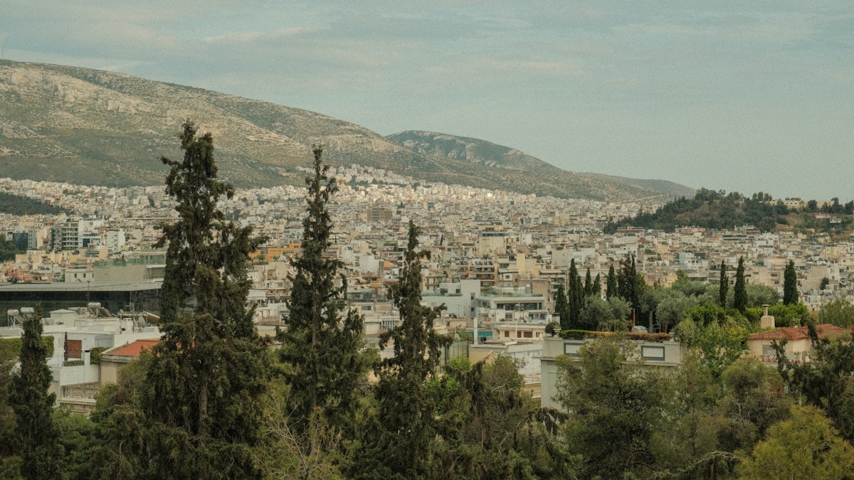 a view of a city with mountains in the background